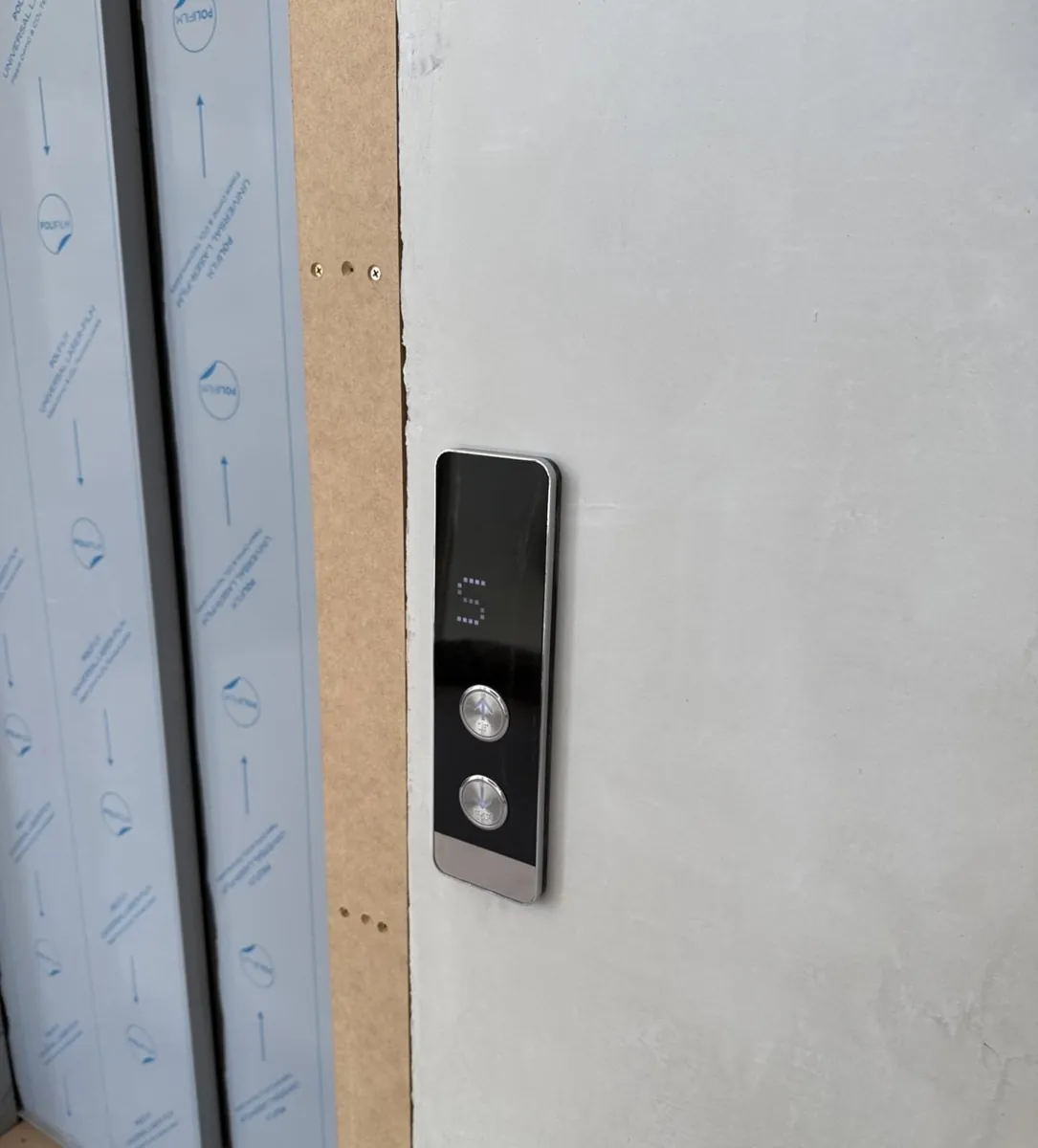 Elevator control panel with black buttons and LED display during installation in Hawthorn, Victoria